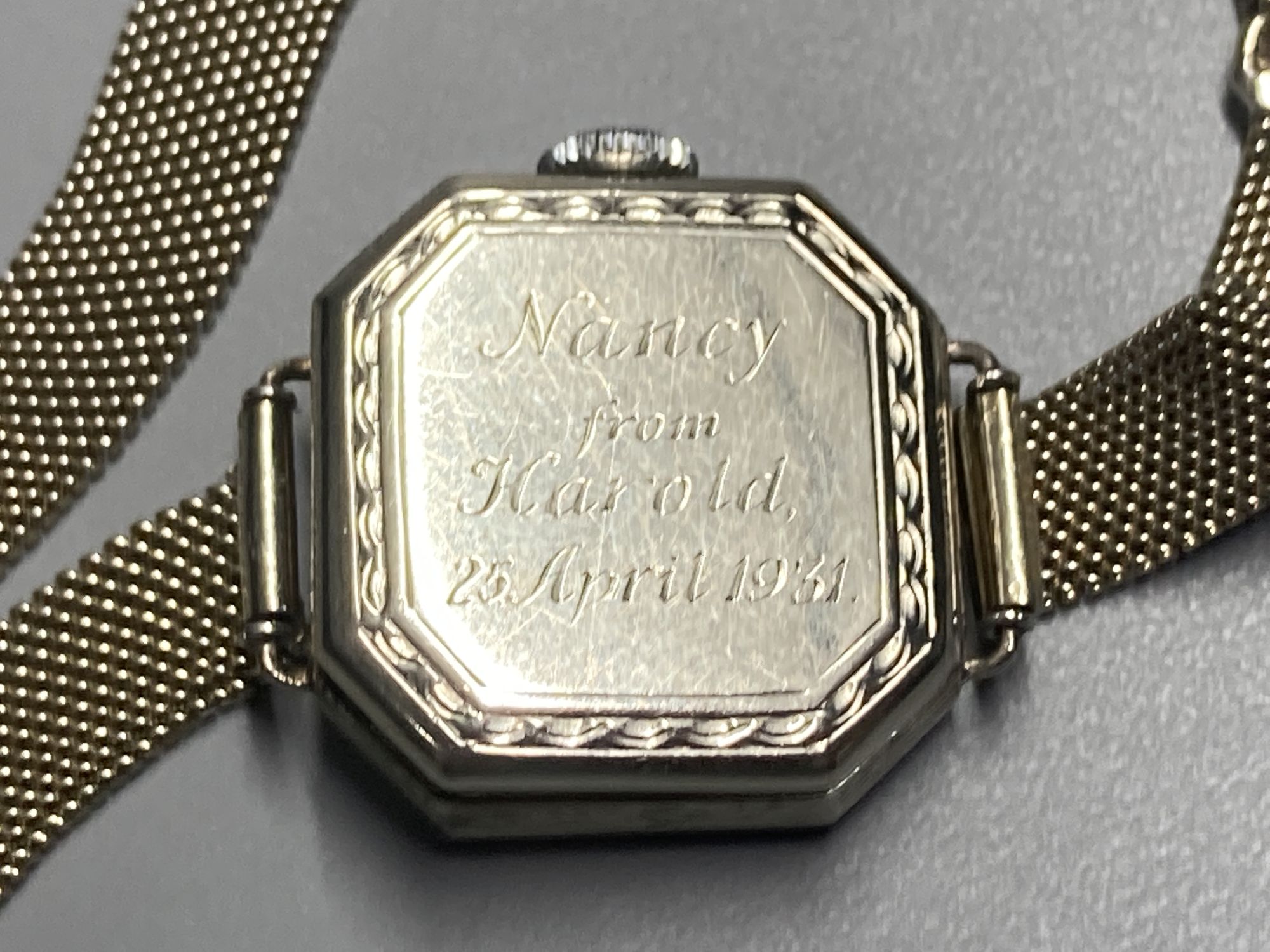 A ladys 1930s white metal and diamond bezel set manual wind wrist watch, on an 18ct mesh link bracelet,